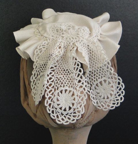 A lace jabot has been re-purposed to decorate the back.